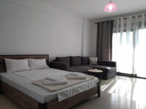a bedroom with a large bed and a couch at Beauty Home Orestiada Center in Orestiada
