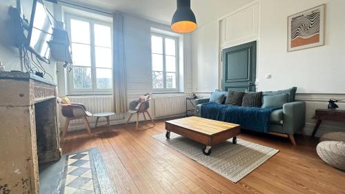 a living room with a couch and a coffee table at Le repère de la cathédrale - Metz Hypercentre in Metz