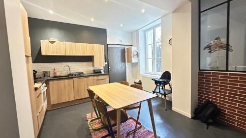 a kitchen with a table and a counter top at Le repère de la cathédrale - Metz Hypercentre in Metz
