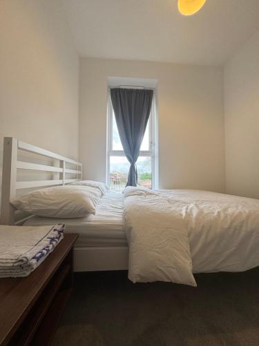 a bedroom with two beds and a window at Blissful Abode in Birmingham