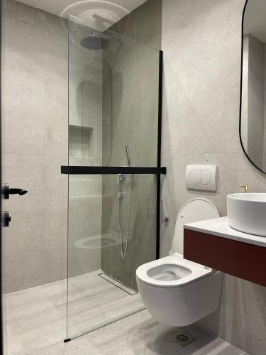 a bathroom with a shower and a toilet and a sink at Krug in Loznica