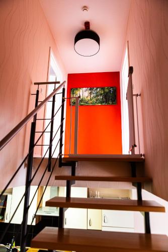 a staircase with a red door and a red wall at Landkulturhof Glücksbringer in Rudolstadt