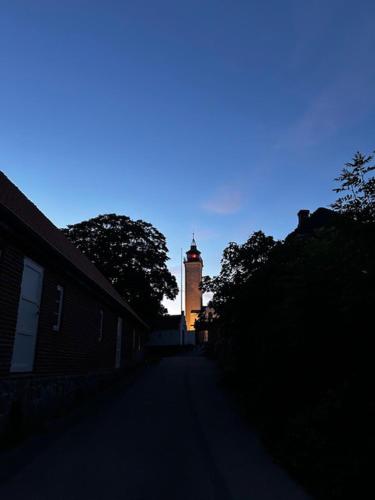 a building with a clock tower in the distance at Holiday home on Tunø - island of the year 2024 in Tunø