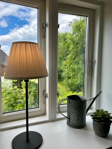 a lamp sitting on a table in front of a window at Holiday home on Tunø - island of the year 2024 in Tunø
