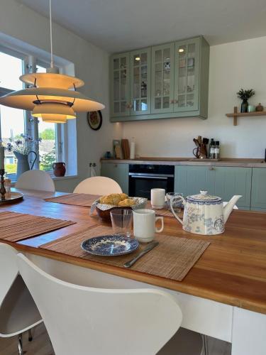 a kitchen with a wooden table with food on it at Holiday home on Tunø - island of the year 2024 in Tunø
