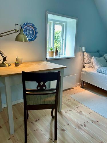 a desk with a chair and a table with a mirror at Holiday home on Tunø - island of the year 2024 in Tunø
