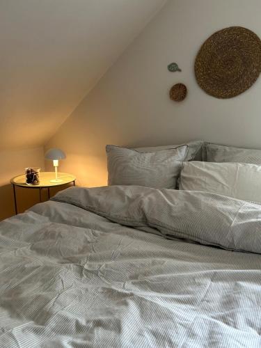 a bed with white sheets and pillows in a bedroom at Holiday home on Tunø - island of the year 2024 in Tunø