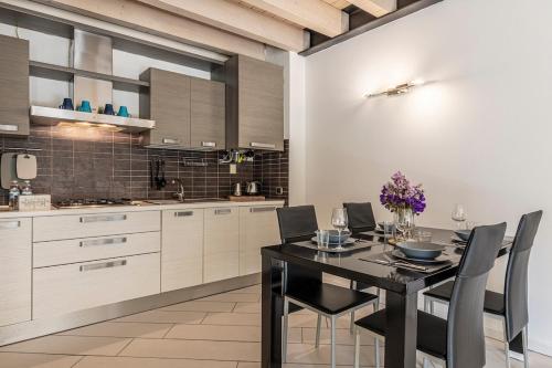 a kitchen with a dining room table and chairs at Barbudo's House in Lonato del Garda
