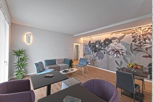 a living room with tables and chairs and a wall mural at Civico 4 Affittacamere in Conscio