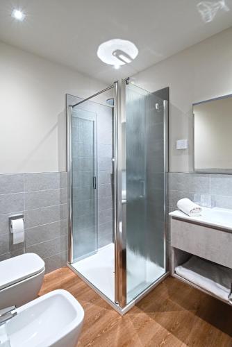 a bathroom with a shower and a toilet and a sink at Civico 4 Affittacamere in Conscio