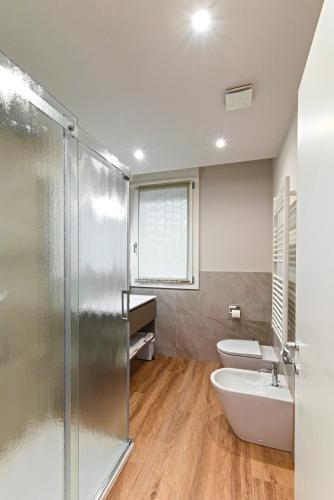 a bathroom with a shower and a sink and a toilet at Civico 4 Affittacamere in Conscio