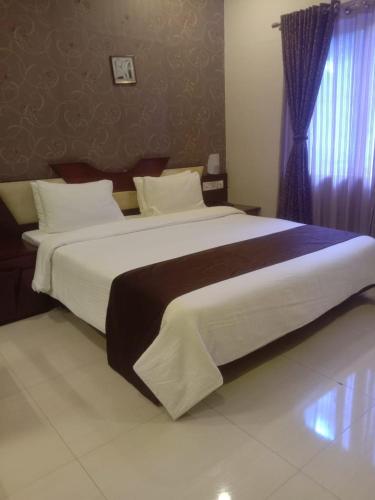 a bedroom with a large bed in a room at Hotel citypalace in Trivandrum