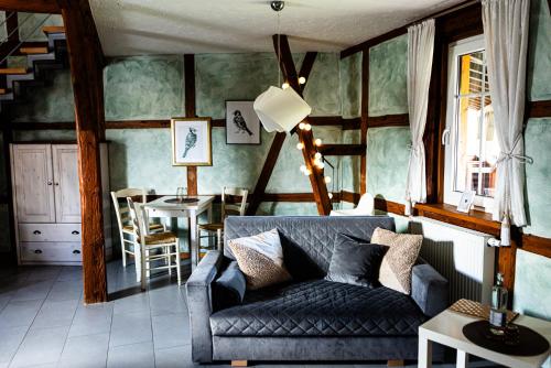 a living room with a couch and a table at Landkulturhof Glücksbringer in Rudolstadt