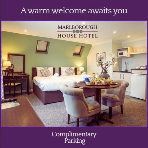 a room with a bed and a table and a kitchen at Marlborough House - Guest House in Oxford