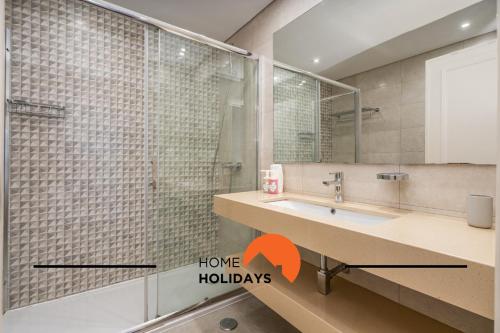 a bathroom with a shower and a sink with a mirror at #250 Apartamento 264 by Home Holidays in Branqueira