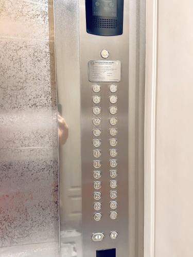 a close up of a door with a remote control at Lavish The Peak 2BR Apartment in Tunjungan Plaza 5 Surabaya City Centre by Le Ciel Hospitality in Surabaya