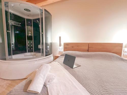 a bedroom with a bed with a laptop on it at Destiny home soave in Soave