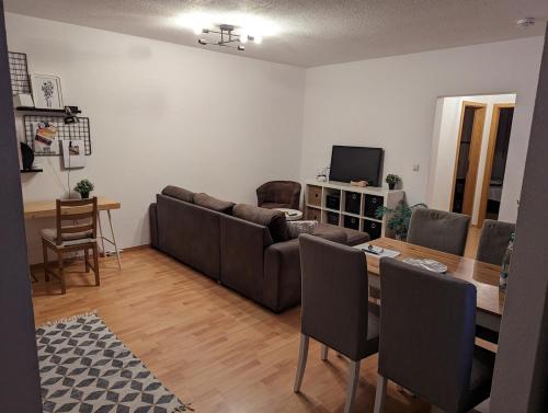 a living room with a couch and a table at Zentrumsnahe Wohnung mit Sonnenterrasse in Leipzig