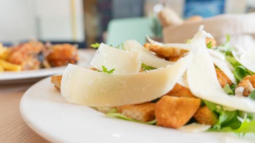 a plate of food with a salad on a table at Hotel Sardinero Madrid in Madrid