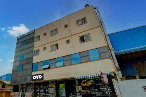 a tall building with windows on the side of it at Hotel O VBH Inn in Bengaluru