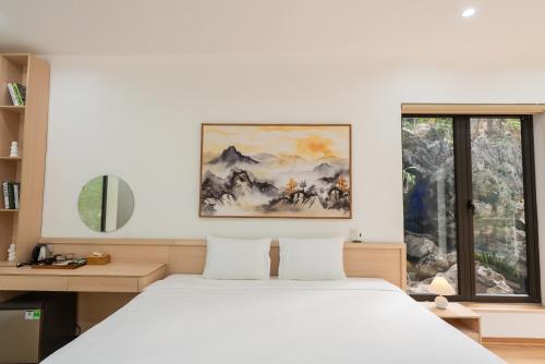 a bedroom with a white bed and a window at Thiên Trường An Garden in Ninh Binh