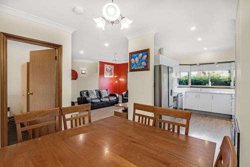 a dining room and living room with a table and chairs at Apartments on Tolmie in Mount Gambier