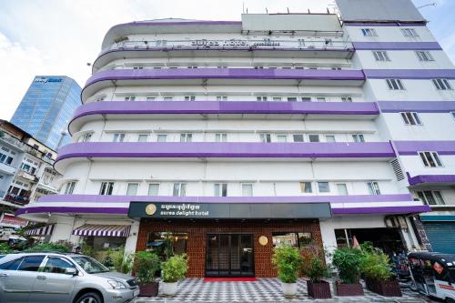 a tall white building with purple trim at Aurea Delight Hotel in Phnom Penh