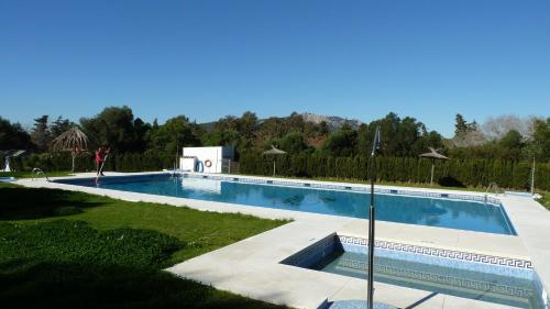 a large swimming pool in a yard with grass at TAIGA Tarifa Valdevaqueros in Tarifa