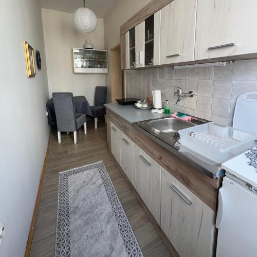 a kitchen with a sink and a counter top at Square View Apartment in Užice
