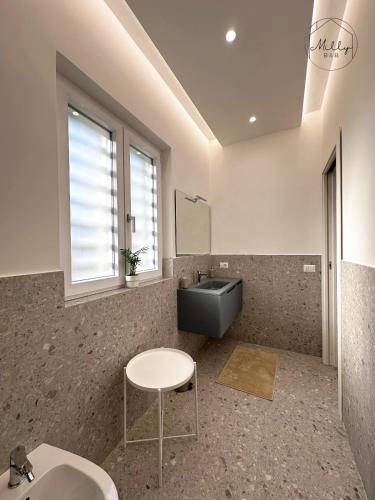 a bathroom with a sink and a mirror and a table at B&B Villa Milly in Frattaminore