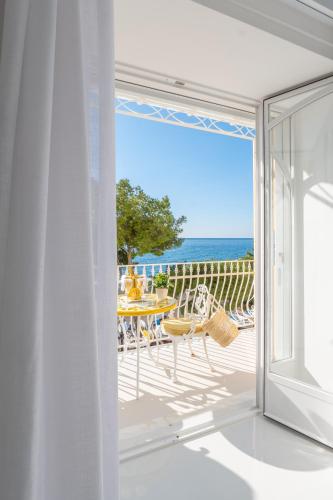 an open door to a balcony with a view of the ocean at La Sirenetta Luxury Suite Positano in Positano
