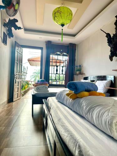 a bedroom with two beds and a large window at NGO KHANH Homestay in Tân Hiệp