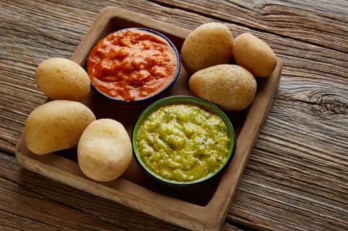 a tray with potatoes and a bowl of guacamole at Bahia Principe Luxury Tenerife - Adults Only in Adeje