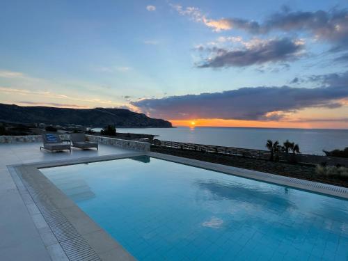 a swimming pool with a view of the water at C'est La Vie Beach Villa in Amoopi