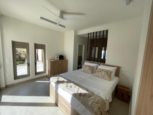 a bedroom with a large bed and a window at C'est La Vie Beach Villa in Amoopi