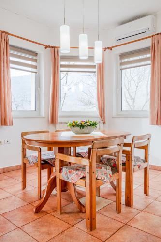 a dining room with a wooden table and chairs at Apartma Brešan in Kobarid