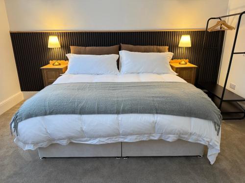 a bedroom with a large bed with two night stands at Spacious, Worcester city centre 2 bedroom apartment in Worcester