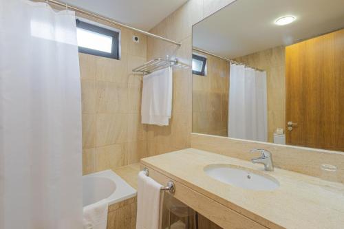 a bathroom with a sink and a mirror at Hotel da Graciosa in Santa Cruz da Graciosa