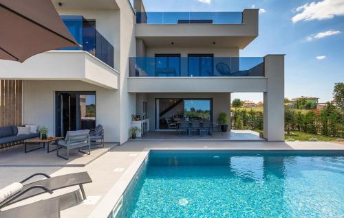 a house with a swimming pool in front of a house at Villa IVaLA in Pula