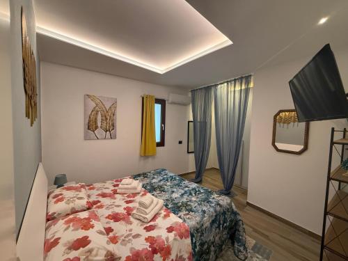 a bedroom with a bed and a television in it at Dimora Palermo with private pool in Palermo