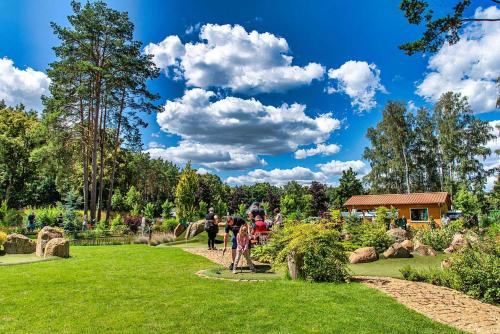 a group of people walking in a park at Bungis - 28 Ferienhäuser Am Grimnitzsee G4 in Joachimsthal