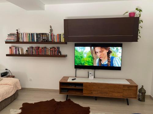 a living room with a flat screen tv on a wall at Casas do Convento in Minde