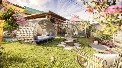 a garden with a swing in the yard at Luxus Alpin Chalet & Traumblick Nockberge auf H1200m in Plessnitz
