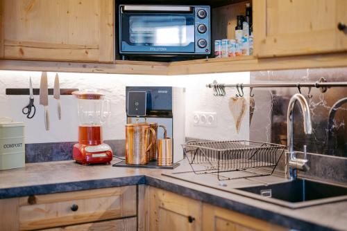 a kitchen with a counter with a sink and a mixer at Luxus Alpin Chalet & Traumblick Nockberge auf H1200m in Plessnitz