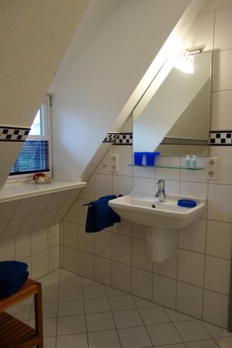 a bathroom with a sink and a mirror at Ferienhaus Süderende 50 in Süderende