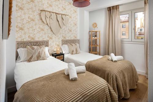 Posteľ alebo postele v izbe v ubytovaní WonderStays Apartamentos Morgan