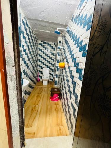 a small bathroom with a toilet and a sink at Shanti Paying Guest House in Mathura