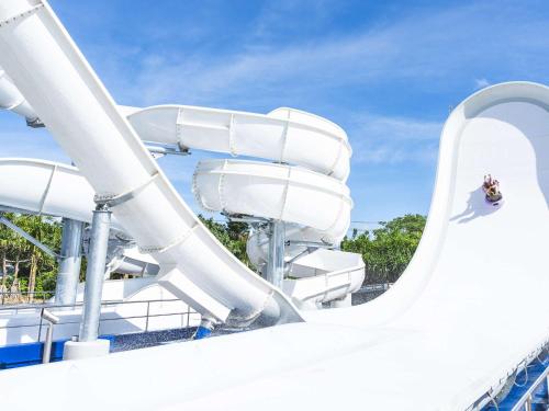 a person riding a water slide on a roller coaster at Grand Mercure Okinawa Cape Zanpa Resort in Yomitan