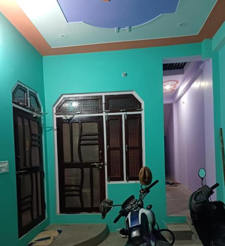 a room with a motorcycle parked in front of a door at Swastik HomeStay in Ayodhya