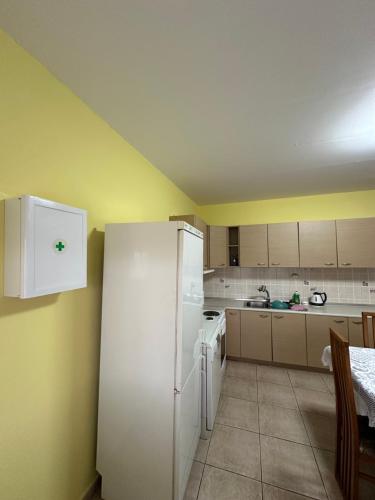 a kitchen with white appliances and a white refrigerator at Veaki Beach House in Xanthi
